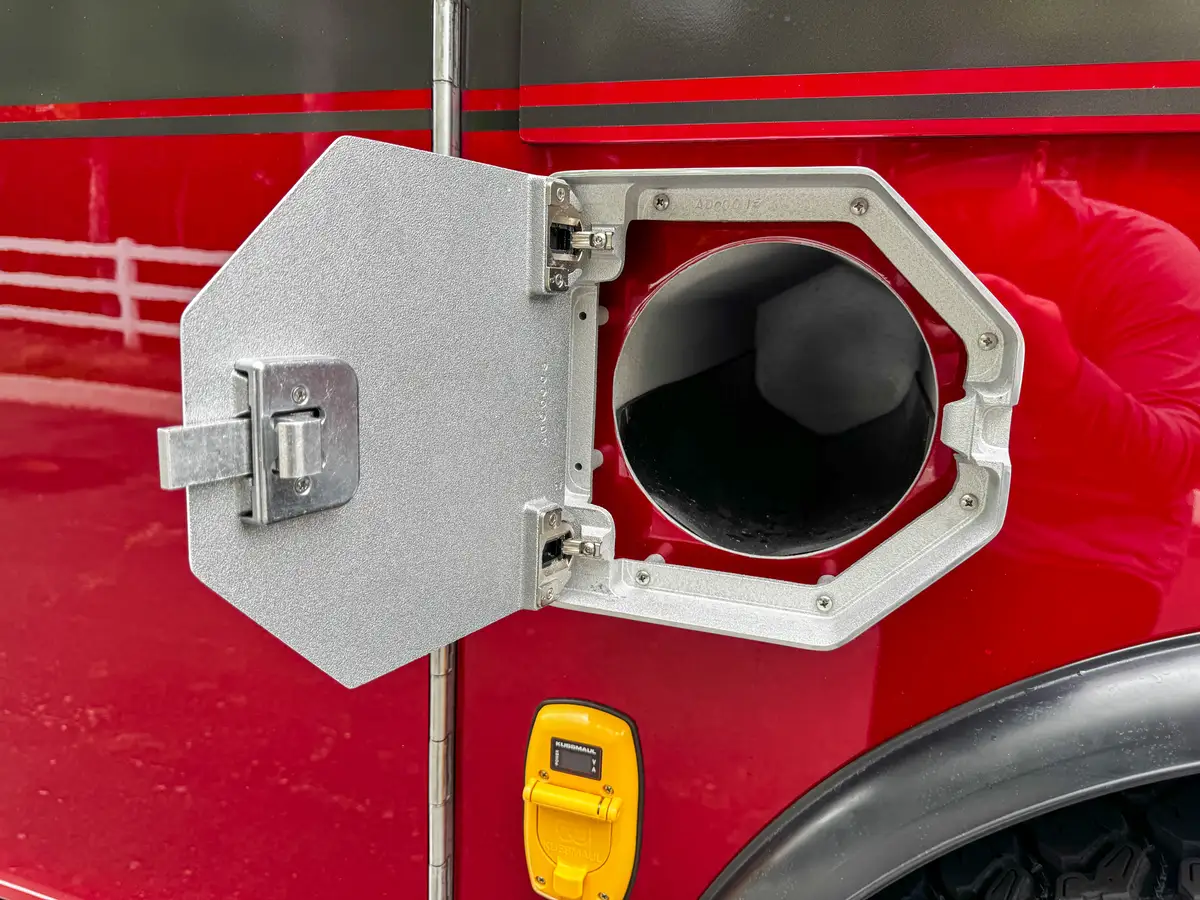 Open side compartment with shelf and door swung outward.